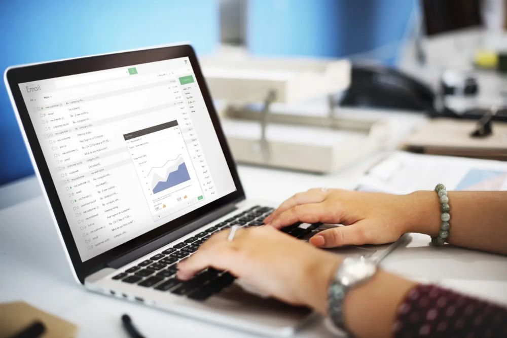 A data analyst working on a laptop