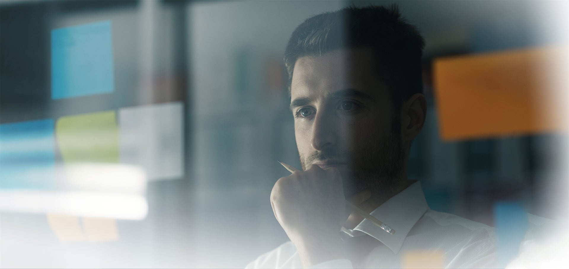Man staring and pondering at a screen.
