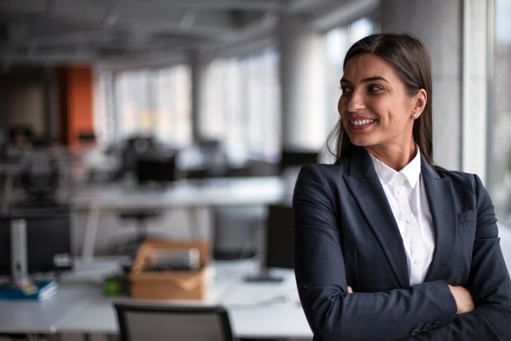 A smiling CFO with her arms crossed.