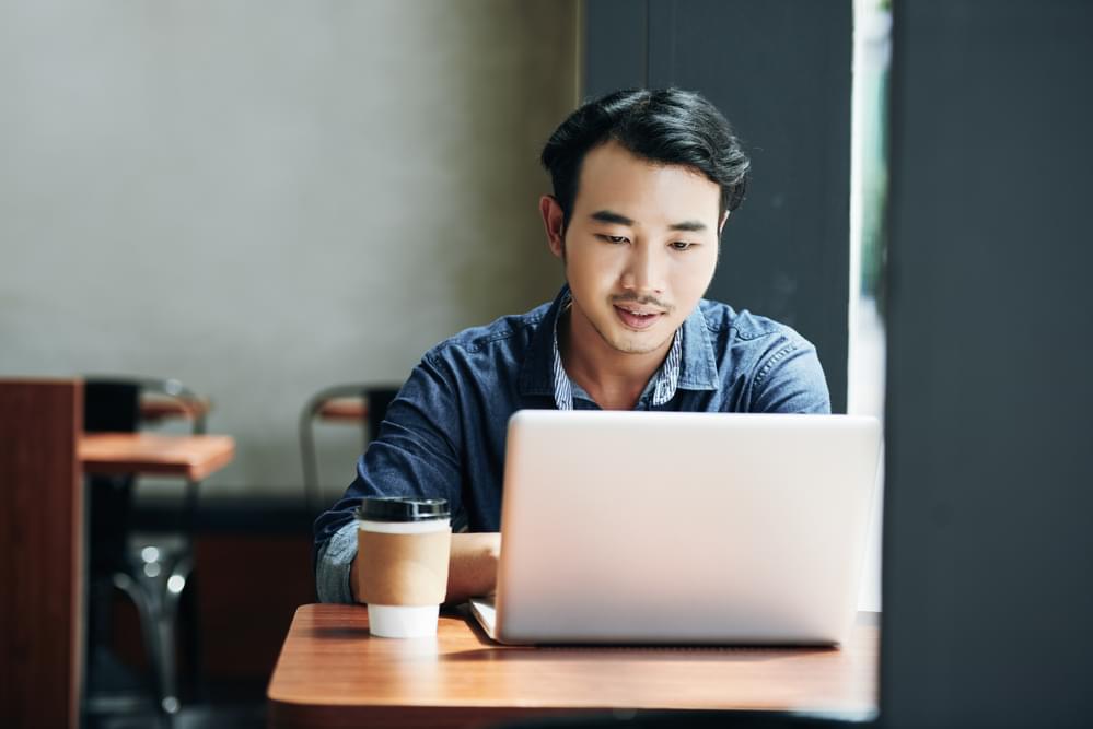 A HR professional working on a laptop.