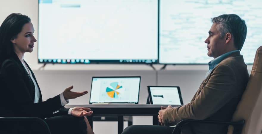 A female data analyst presenting some customer insight findings to a CEO.