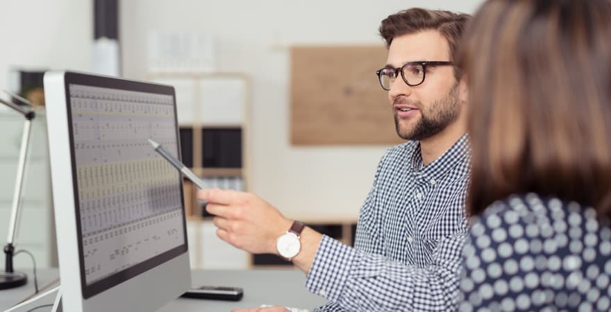 Two male and female data analysts reviewing a business strategy using the data they have collected.