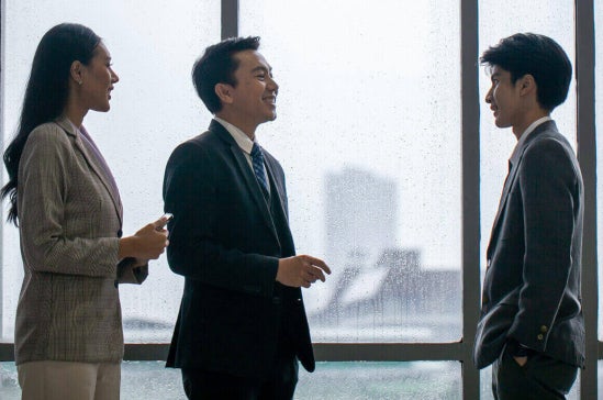 A group of business professionals discussing business deals in the office.