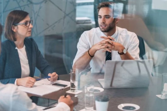 A data analyst advising his colleagues at an executive board meeting