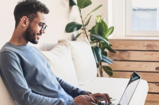 A cyber security professional working on a laptop