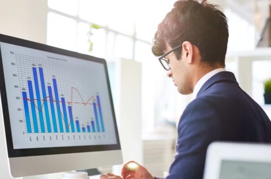A fintech expert working at his computer