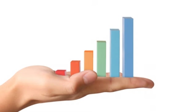 A hand holds colorful bar graphs, symbolizing how descriptive analytics brings quantitative insights and clear visualization from raw data.
