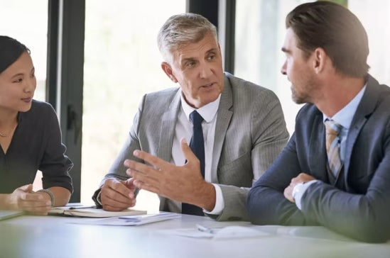 A chief data scientist in a discussion with other data scientists