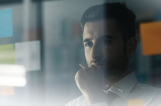 Man staring and pondering at a screen