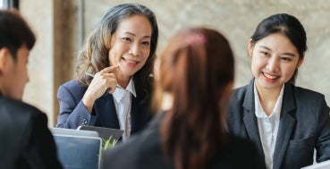 Senior manager leading a discussion with a seated team.