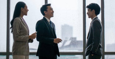 A group of business professionals discussing business deals in the office.