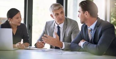 A chief data scientist in a discussion with other data scientists