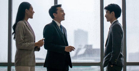 A group of business professionals discussing business deals in the office.