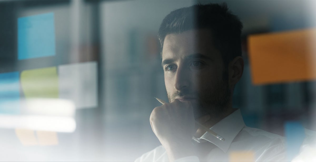 Man staring and pondering at a screen.