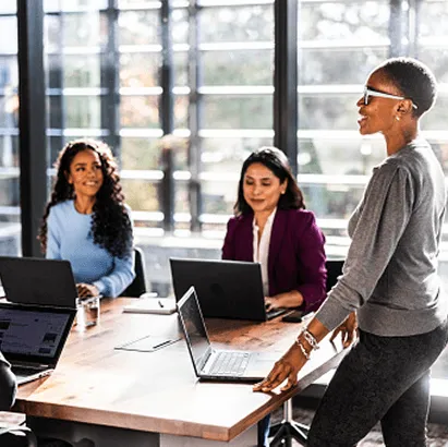 Group of professionals collaborating around a table in a meeting space.
