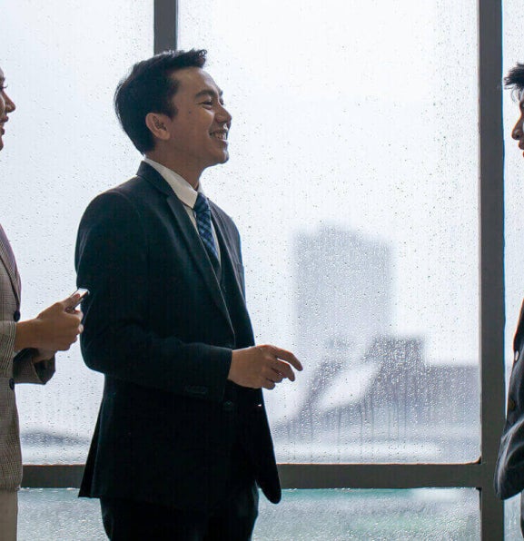 A group of business professionals discussing business deals in the office.