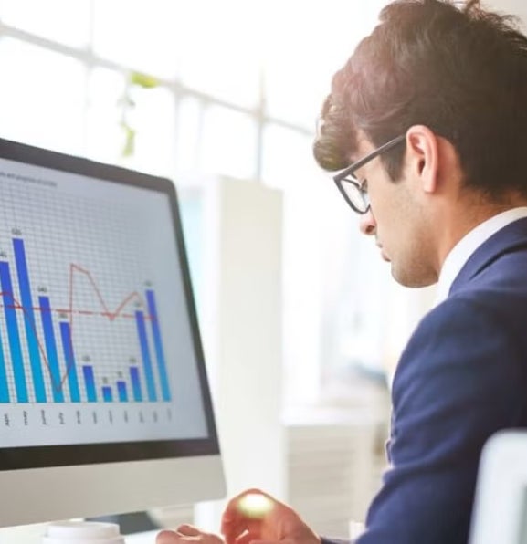 A fintech expert working at his computer