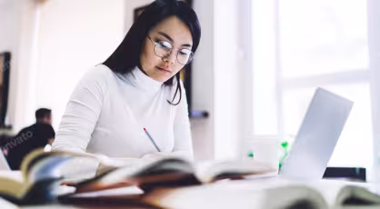 Mid-career professional in Singapore studying for a Master of Analytics on a laptop