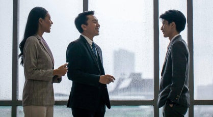 A group of business professionals discussing business deals in the office.