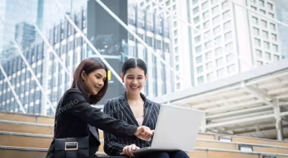 Professionals researching in-demand jobs in Singapore on a laptop