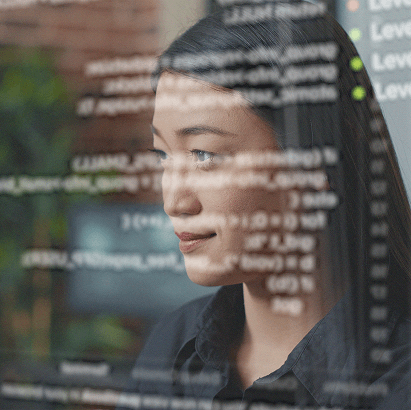 Professional focused on a computer screen displaying technical information.
