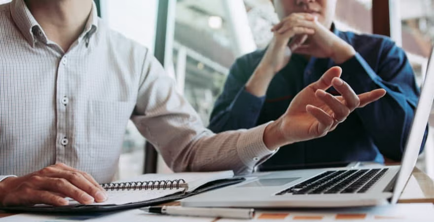 A data analyst presenting his findings to a business owner