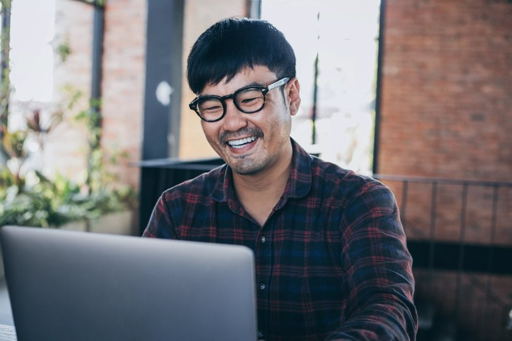 A finance expert working happily on his laptop